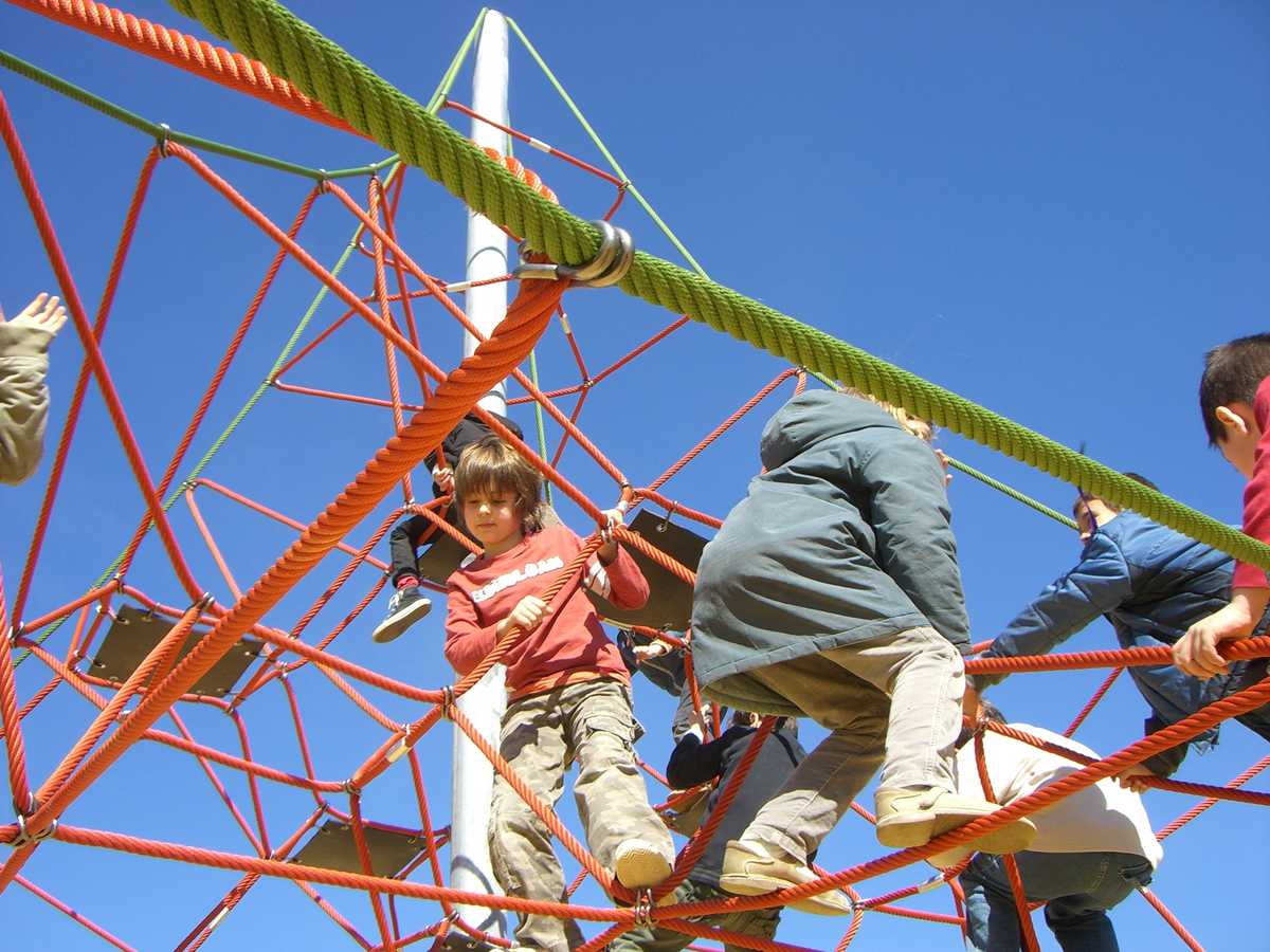 Gros plan du sommet de la pyramide de corde avec plusieurs enfants qui jouent